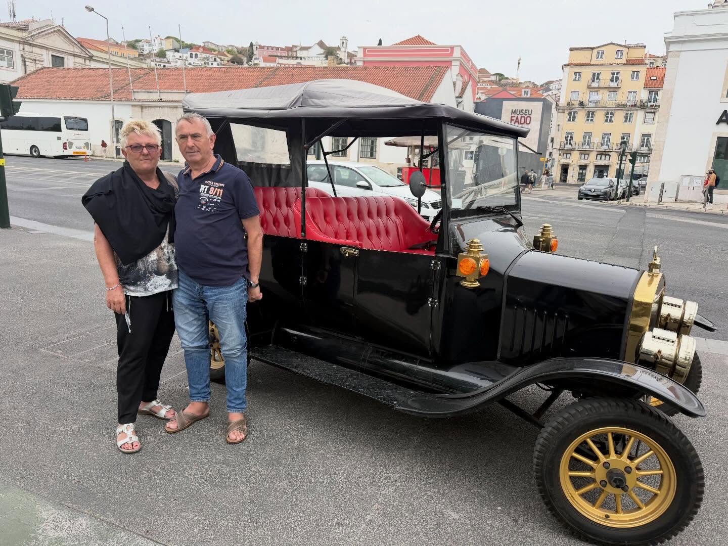 Happy customers with tour guide on a tuk tuk tour in Lisbon