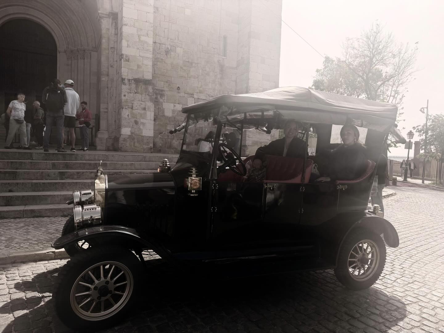 Happy customers with tour guide on a tuk tuk tour in Lisbon