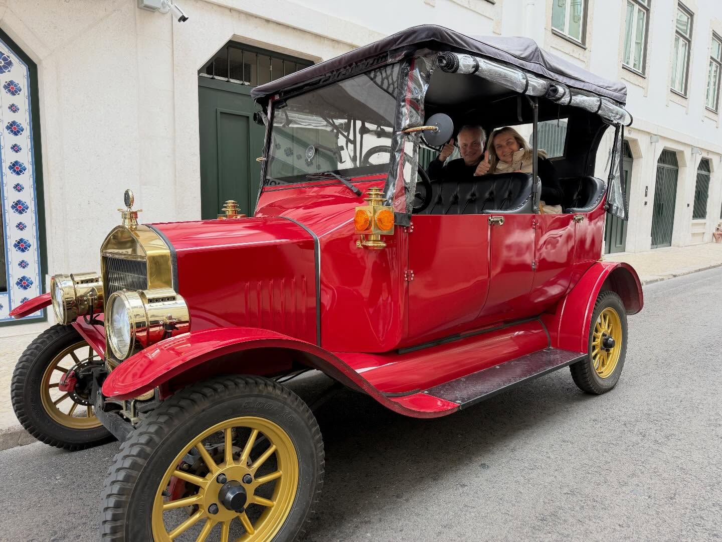 Happy customers with tour guide on a tuk tuk tour in Lisbon