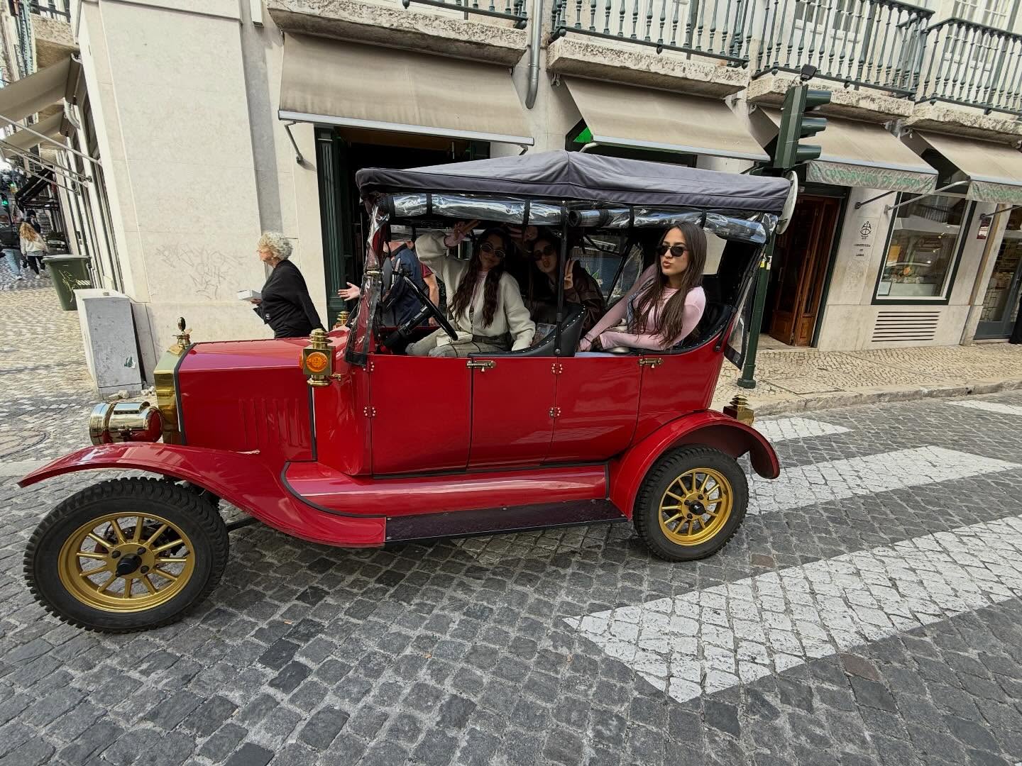 Happy customers with tour guide on a tuk tuk tour in Lisbon
