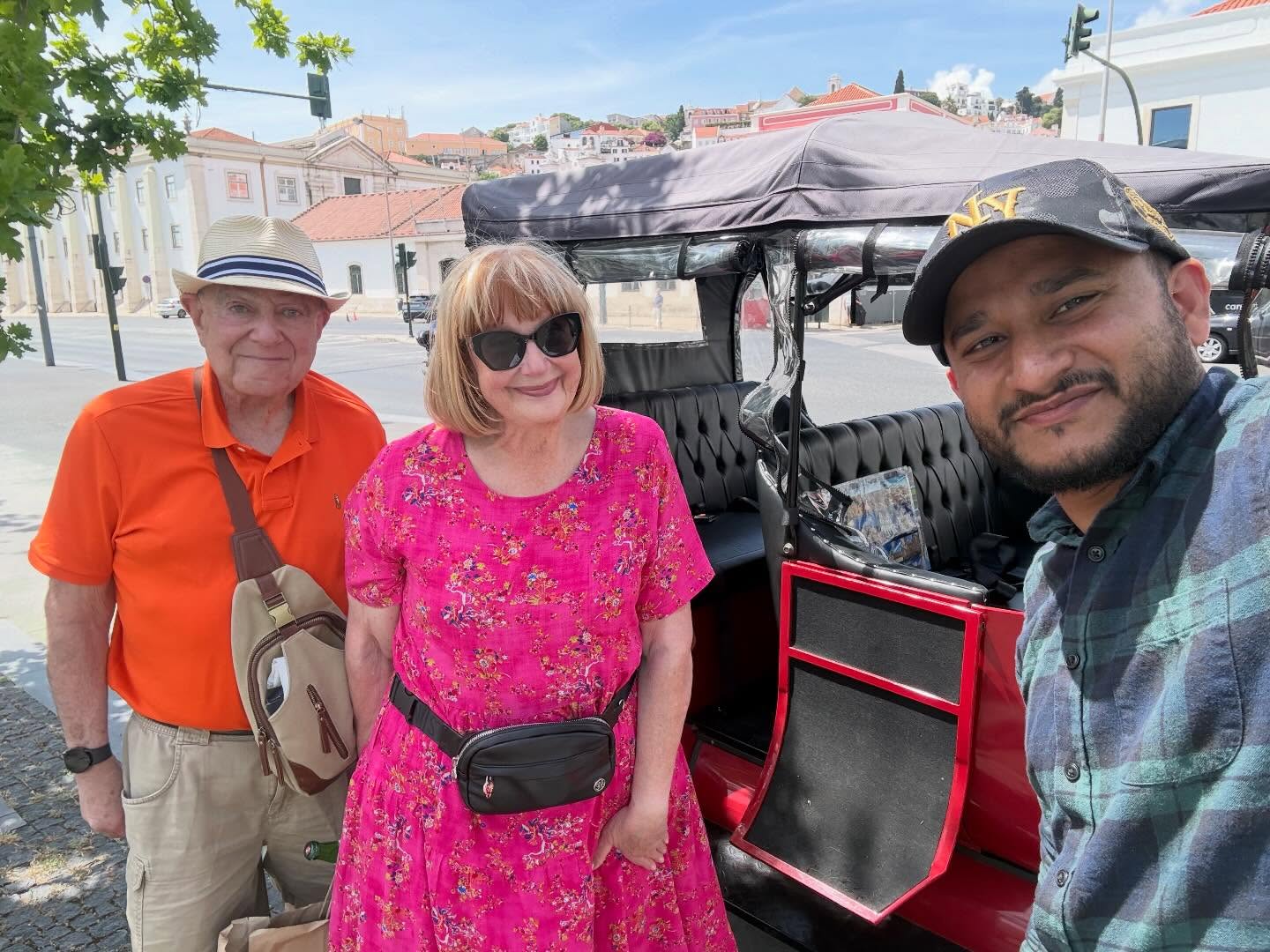 Happy customers with tour guide on a tuk tuk tour in Lisbon