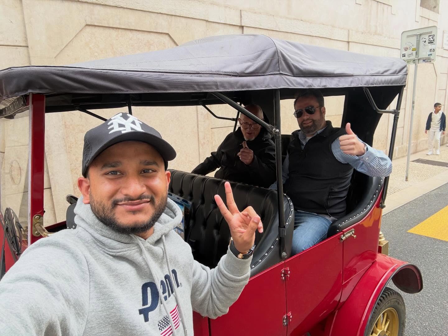 Happy customers with tour guide on a tuk tuk tour in Lisbon